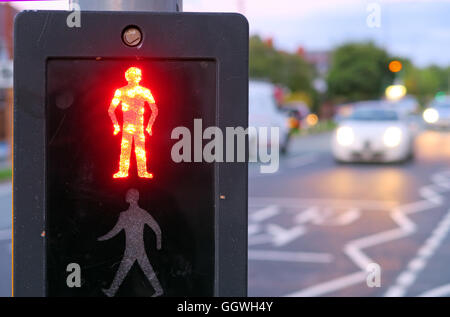Red man at UK Pelican Crossing, with evening traffic in background Stock Photo