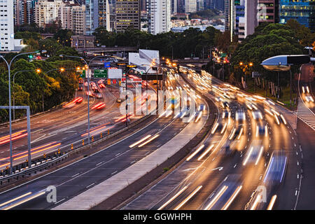 Busy warringah freeway motor road going through Sydney city CBD at sunset. Intense traffic lights blurred at long exposure again Stock Photo