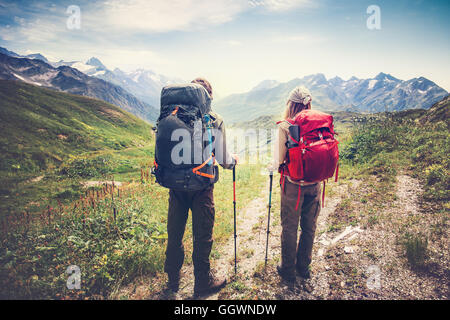 Couple Man and Woman Travelers backpackers mountaineering Travel Lifestyle and relationship love concept mountains landscape on Stock Photo