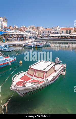 A boat berthed at the seaside resort town of Agios Nikolaos located on the north-ea Stock Photo