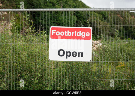 Footpath Open Sign. Public Information Notice on Metal Fence with Green Rural Background. Stock Photo