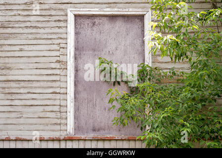 abandoned wooden house with boarded up windows Stock Photo