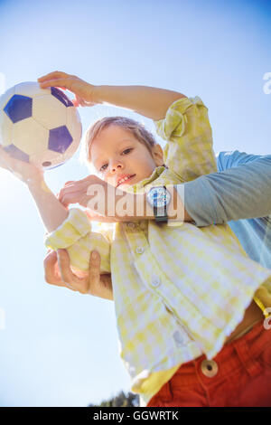 Young boy holding soccer ball Stock Photo