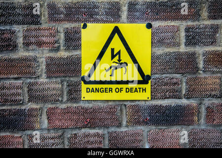 'Danger of Death' sign on brick wall - Berkhamsted, UK Stock Photo