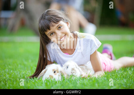 Smiling girl with pet rabbits Stock Photo