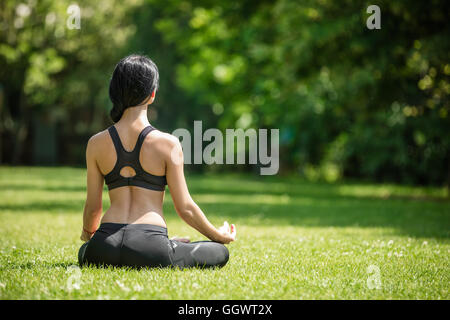 Young girl practicing yoga outdoors Stock Photo