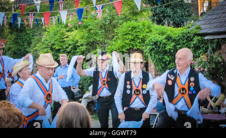 Morris dance is a form of English folk dance dating to the 1400's with rhythmic stepping, wielding sticks, swords, handkerchiefs Stock Photo