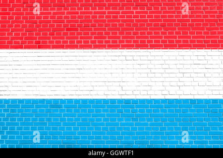 Flag of Luxembourg on brick wall texture background. Luxembourgish national flag. Stock Photo