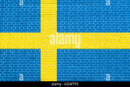 Flag of Sweden on brick wall texture background. Swedish national flag. Stock Photo