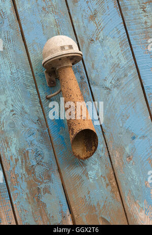 Old rusted sound horn on a blue weathered wooden background Stock Photo