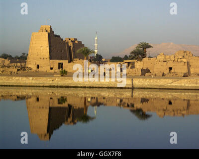 Dawn light reflection of the Temple of Karnak in the Sacred Lake in the Temple of Karnak at Luxor – Egypt. Stock Photo