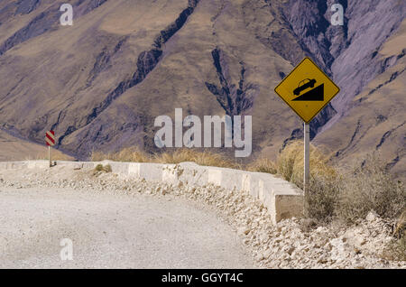Steep descent on an Andean dirt road in Argentina Stock Photo