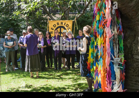 London, UK. 6th August 2016. London CND held a ceremony in memory of the victims, past and present on the 71st anniversary of the dropping of the atomic bomb on Hiroshima and the second atomic bomb dropped on Nagasaki three days later. The event ended with everyone, led by Raised Voices Peace Choir singing 'The H-Bombs Thunder'. Peter Marshall/Alamy Live News