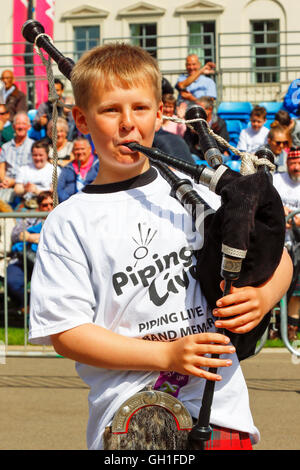 Glasgow, Scotland, UK. 08th Aug, 2016. On the first day of 'Piping Live', an annual festival of bagpipe music held in various venues across the city, several of the international participating pipe bands gave free concerts in George Square. The picture is of ALY WILLIAMS, aged 11, from Dunblane, Scotland who was playing in a demonstration to raise fund for the charity ASTHMA UK. Credit:  Findlay/Alamy Live News Stock Photo