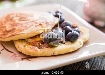 Tasty Pancakes closeup with a blueberries and maple syrup garnish. Stock Photo