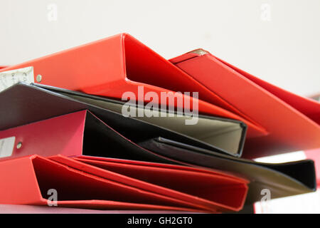 Messy pile of red & black ring binders Stock Photo