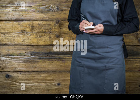 waitress writing down an order in restaurant Stock Photo