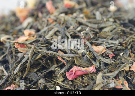 closeup to dried white tea leaves with flower petals Stock Photo