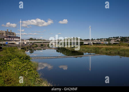The calm waters of the River Towy at Carmarthen with foot and road bridges Stock Photo