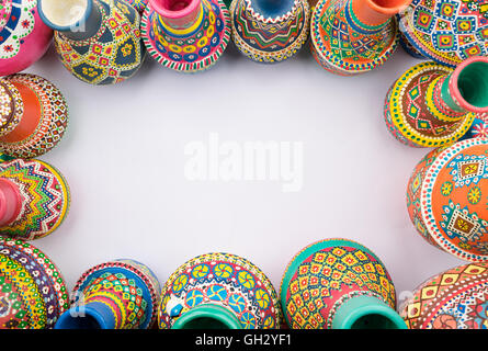 Frame of painted colorful pottery vases on white background Stock Photo