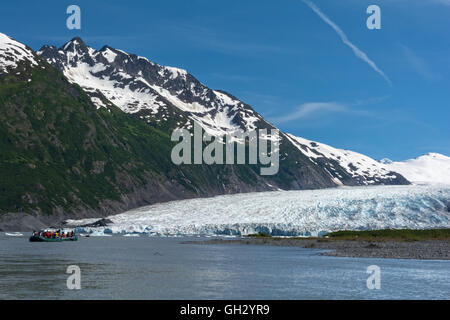 A raft full of people float in the lake created by the melt water from the Spencer Glacier on the Kenai Peninsula in Alaska. Stock Photo