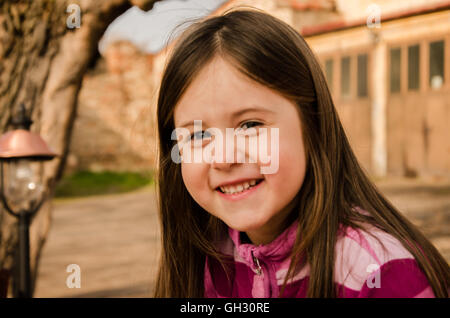 little girl's joy in meeting after the holidays with family,young girl smiling Stock Photo