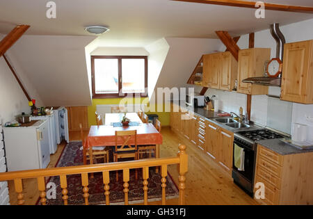 Lubica, PRESOV, SLOVAKIA - JULY 07, 2016: The interior of big kitchen with chairs, table and window in slovakian house in Lubica Stock Photo