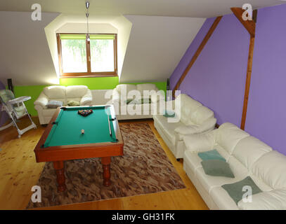 Lubica, PRESOV, SLOVAKIA - JULY 07, 2016: The interior of room with two white divans, billiard-table, window in slovakian house Stock Photo