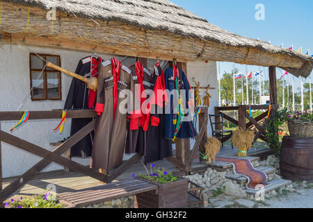 Russia, Ataman - 26 September 2015: Cossack upper uniforms hanging on the veranda. Drying Cossack form. Stock Photo