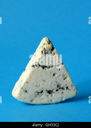 danish blue semi-soft cheese on blue background Stock Photo