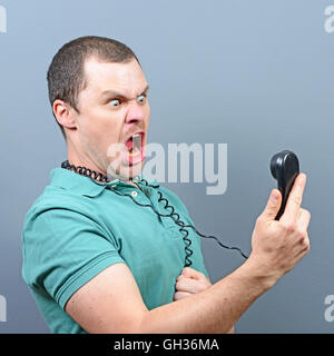 Man having unpleasant conversation on telephone Stock Photo