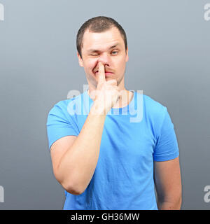 Man putting finger deep in his nose - Bad habit concept Stock Photo