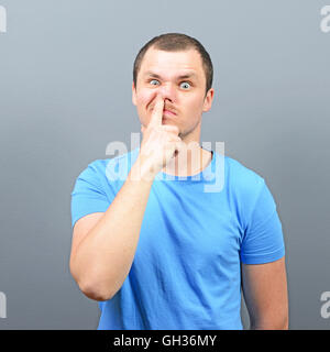 Man putting finger deep in his nose - Bad habit concept Stock Photo