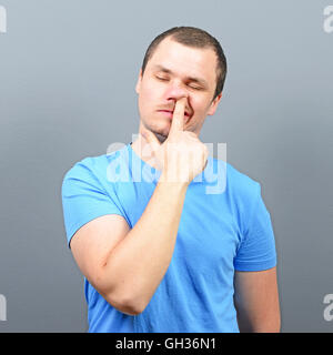 Man putting finger deep in his nose - Bad habit concept Stock Photo