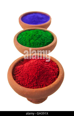 Various colored dyes in earthen bowls isolated on white. Stock Photo