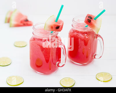 Watermelon smothie and slices on white background Stock Photo