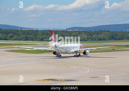 ZURICH - July 30:  Planes preparing for take off at Terminal A of Zurich Airport on July 30, 2016 in Zurich, Switzerland. Zurich Stock Photo