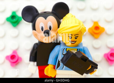 Tambov, Russian Federation - July 24, 2016 Lego girl make selfie with Mickey Mouse. Studio shot. Stock Photo