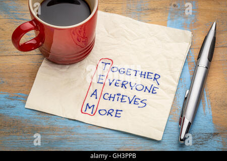 TEAM acronym (together everyone achieves more), teamwork motivation concept - a napkin doodle with a cup of coffee Stock Photo