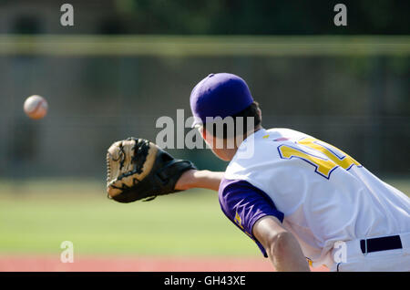 Baseball player catching ball Stock Photo