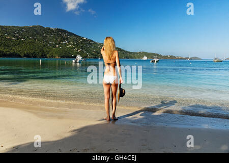 Backside View of a Young Woman in Bikini on a a Beach Looking Out to the Sea, Magens Bay, St Thomas, US Virgin Islands Stock Photo