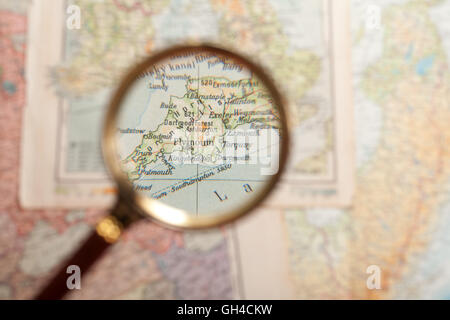 Magnifying glass in front of a Plymouth map Stock Photo