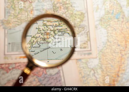 Magnifying glass in front of a Plymouth map Stock Photo