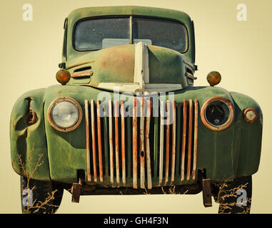 Dented up pick up truck cut out of a junkyard. Isolated with a clipping path. Retro instagram look. Stock Photo
