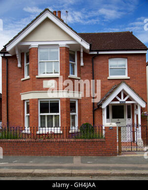 Front view of refurbished Edwardian detached house on English Surrey street with bay windows and front door blue sky Stock Photo