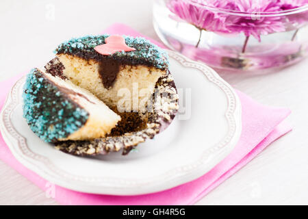 cupcake with chocolate filling decorated with heart. Stock Photo