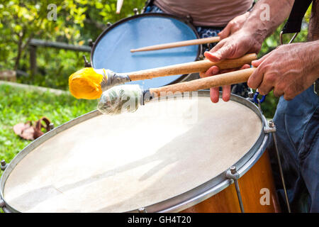 Close-up view of drummers playing in a street marching band during a samba parade. Laveno, Varese. Italy Stock Photo