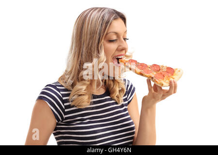 Studio shot of a young woman eating a slice of pizza isolated on white background Stock Photo