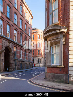 A narrow street and tall buildings. Former Victorian factories and warehouses, typical of the Lace Market area in Nottingham, England, UK Stock Photo