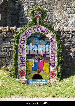 The 2016 well dressing depicting 'The Scarecrows' Wedding' at the Children's Well, Tissington, Derbyshire. Stock Photo